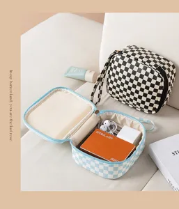 Portable checkerboard storage bag for sanitary napkins and cosmetics, stylish and compact daily organizer.