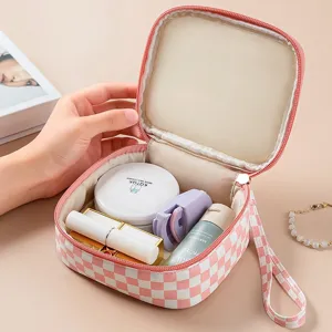 Pink white checkerboard cosmetic bag portable sanitary napkin pouch for women and student daily use.