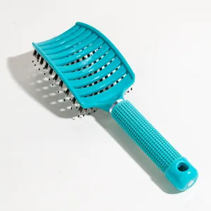 Curved hair brush with natural boar bristles, vented design for fast blow drying and daily hair care.
