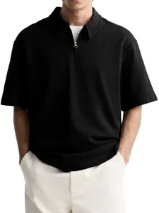 Close-up view of the black textured half-zip polo shirt with turn-down collar and short sleeves.