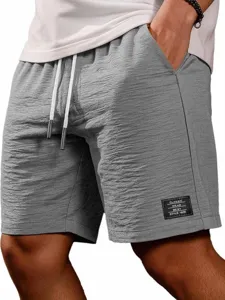 Vista ravvicinata dettagliata di pantaloncini casual da uomo grigi con coulisse bianca.