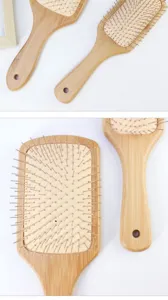 Close-up view of the bamboo hair brush featuring flexible metal pins and ergonomic handle.