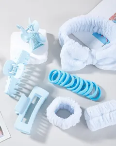 Detailed view of light blue plush headband, hair claws and cute elastic hair ties.