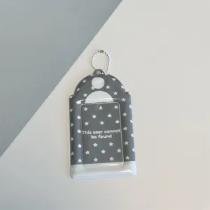 Detail shot of grey star photocard holder, 3 inch ID badge protector with ball chain accessory.