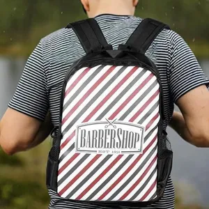 Barbershop themed fashion backpack detail view showcasing striped design and logo print.