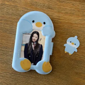 Detailed view of the cute blue cartoon animal photocard holder with a matching mini pendant.