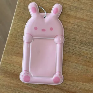 Pink rabbit PVC photocard sleeve detail view, clear card holder pocket with hanging chain.