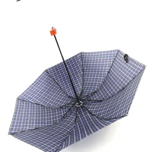 Detail shot of the blue plaid folding umbrella interior, showing sturdy ribs and mini design.
