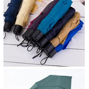 Compact three-fold folding umbrella in multiple vibrant colors, portable mini rain sun umbrella.