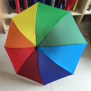 Detailed view of colorful rainbow umbrella panel structure, vibrant long handle design.