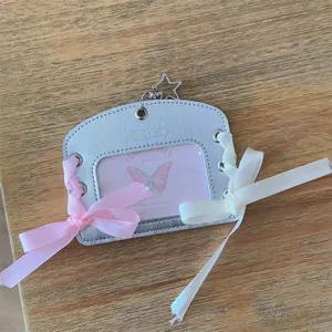 Silver leather photocard holder with ribbons, star charm, and clear window for cards.