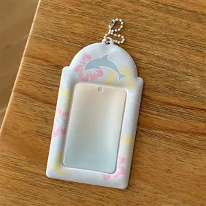 Detail view of the cute photocard holder with dolphin pattern and hanging chain accessory.