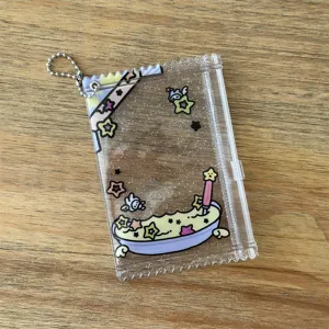 Transparent PVC 3-inch photocard holder with cute star and cartoon print, zipper closure.
