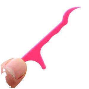 Fil dentaire en plastique rose pour soins bucco-dentaires, cure-dent fin de nettoyage.