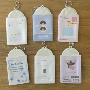 Detailed view of cute 3-inch photo card sleeves with various printed designs and ball chains.