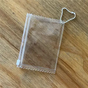 Clear glitter candy shaped card holder detail view with white bead chain and zipper.