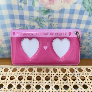 Cute pink double heart photo card holder keychain detail close-up, lovely daily accessory.