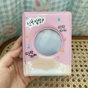 Close up of pink 3 inch mini photocard binder, cute Korean style idol photocard album.