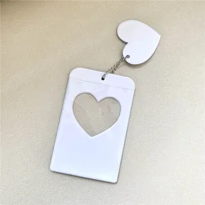 White heart photocard holder idol kpop photocard sleeve with charm keychain accessory detail.