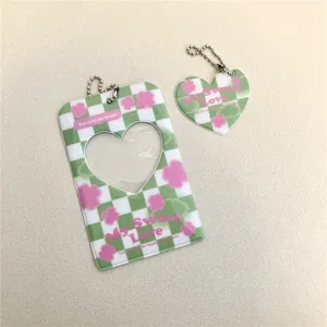 Cute green checkerboard photocard holder with heart cutout and matching keychain pendant.