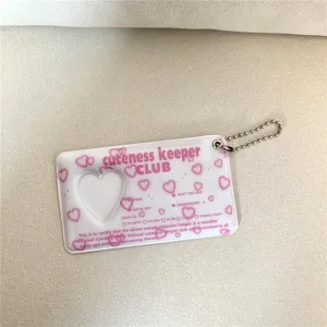 Pink acrylic photocard holder keychain with heart cutout and cute English text design.