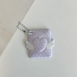 Detailed view of the purple polka dot angel heart card holder with cute wings and pearl chain.