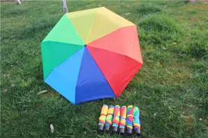 Colorful rainbow umbrella detail showing vibrant multi-color panels and folded umbrellas.
