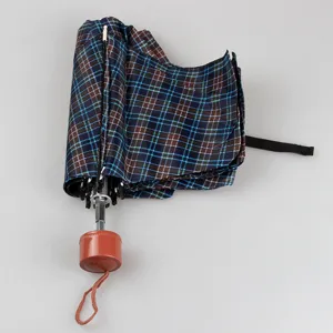 Compact three-fold plaid umbrella, mini portable sun and rain umbrella for daily use.