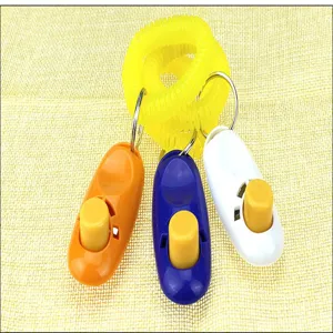 Dettaglio di clicker per addestramento cani colorati con comodo braccialetto elastico.