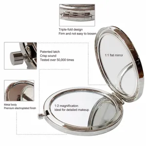 Espejo de maquillaje de metal plegable de doble cara portátil con vista normal y ampliada.