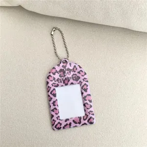 Detailed close-up shot of the pink leopard print acrylic photocard holder keychain pendant.