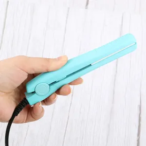 Close-up detail shot of a mini portable hair straightener in light blue color with cord.