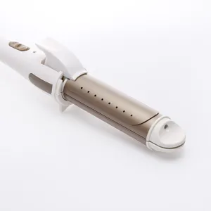 Detailed close-up of the white and gold hair styling tool showing clamp and ventilation vents.