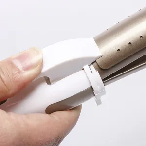 Detail view of a 2-in-1 hair straightener and curler in white and champagne gold with lock mechanism.