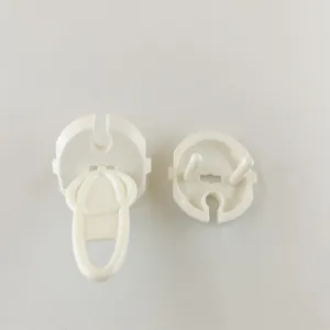 Close up view of white plastic safety plug cover for French electrical socket child protection.