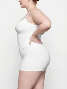 Detail view of plus-size white camisole and shorts set, elastic and comfortable fit.