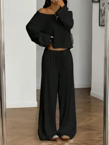 Detailed view of casual black off shoulder long sleeve top and wide leg trousers set.