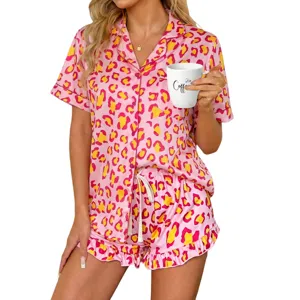 Close-up detail of women's pink leopard print short-sleeve pajama shirt and ruffle shorts.