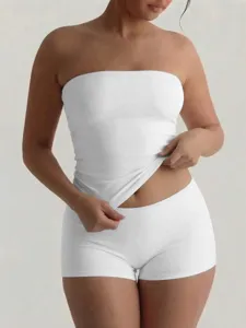 Close-up detail of basic white strapless tube top and matching shorts set, slim fit.