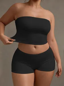 Detailed shot of elastic black strapless crop top and shorts set, showcasing soft fabric and fit.