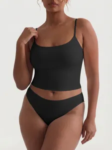 Close-up detail of black camisole and matching briefs set, featuring smooth stretchy fabric.