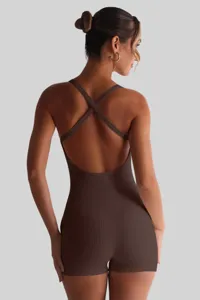 Back detail view of women's ribbed sleeveless romper showcasing cross straps and fitted cut.