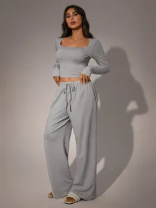 Grey two-piece lounge set with a square neck long-sleeve crop top and wide-leg pants.