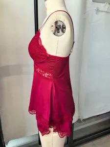 Red lace camisole and shorts sleepwear detail view showing delicate trim and adjustable strap.