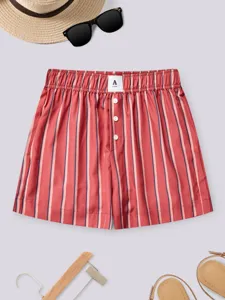 Close-up detail of women's vertical striped casual shorts with elastic high waist and buttons.