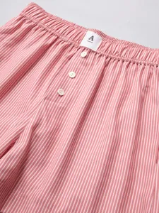 Pink striped women's casual lounge shorts detail showing elastic waistband and buttons.