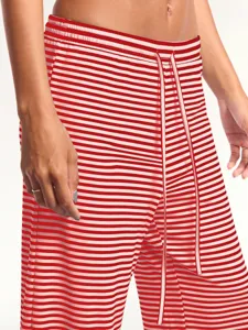 Detail view of red and white striped casual pants featuring adjustable drawstring waist.