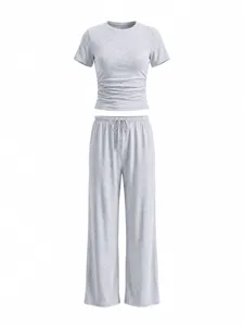 Detailed view of grey casual two-piece lounge set, featuring a ruched crop top and wide pants.