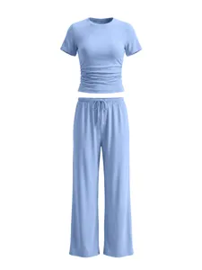 Detail shot of light blue casual top with ruched waist and matching wide leg drawstring pants.