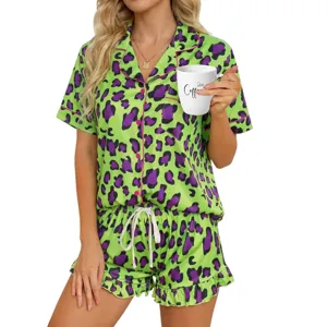 Close-up detail of the vibrant green and purple leopard print pajama set, showing collar and button.
